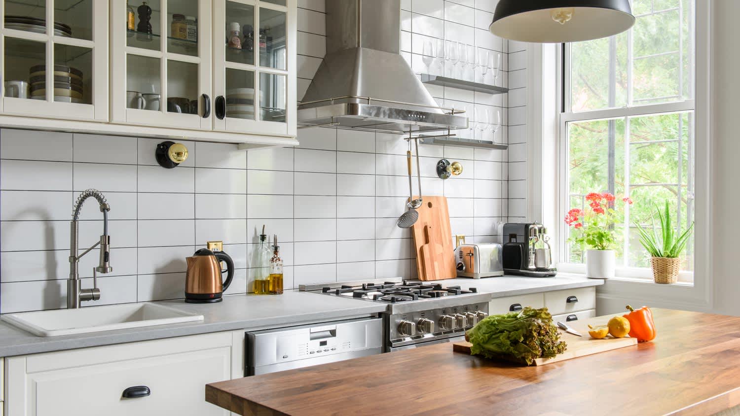 A bright kitchen with a floating island in the middle of it