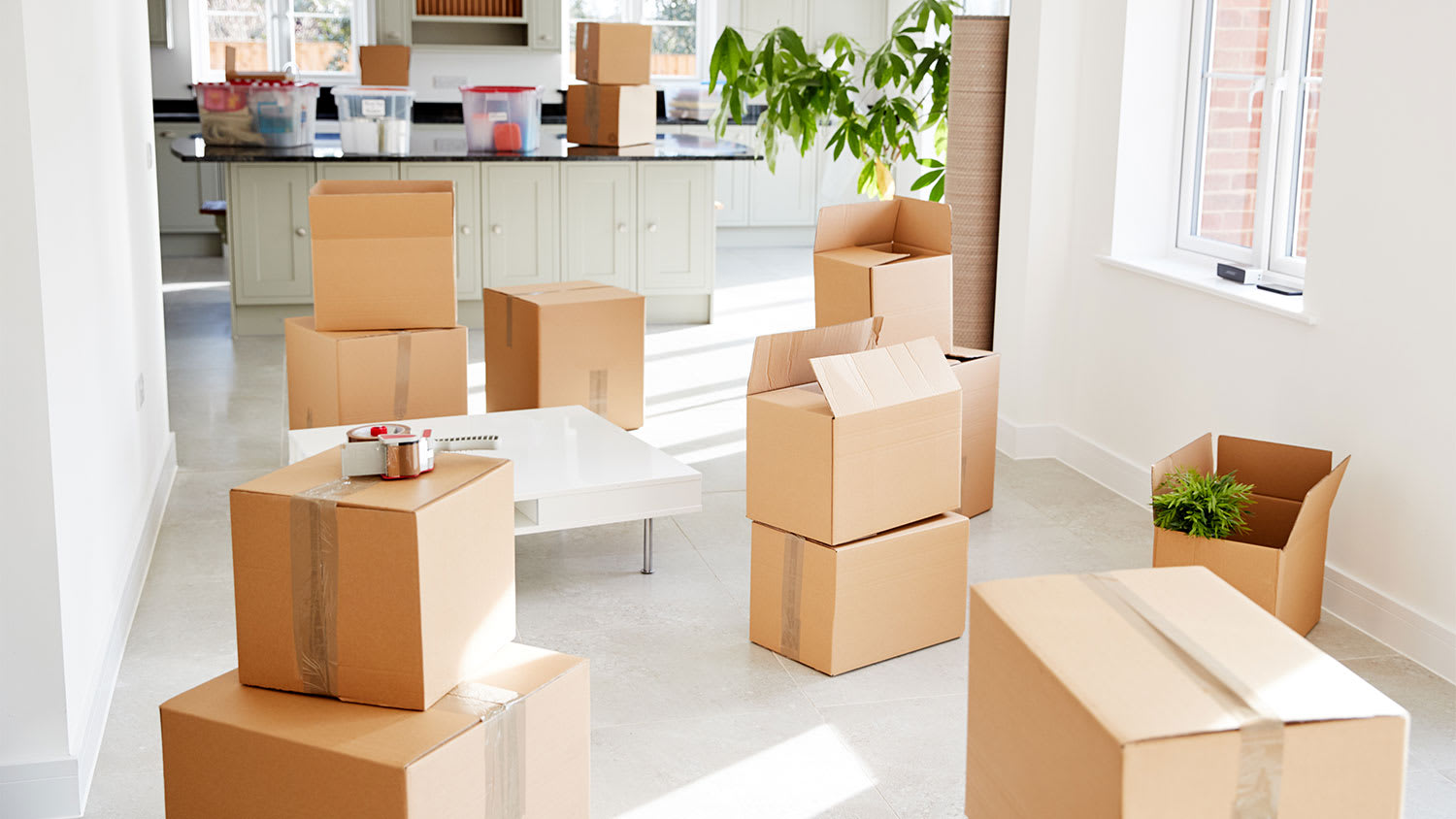 Empty house room with staked moving boxes