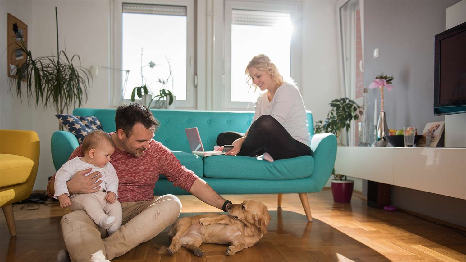family hanging out with dog at home