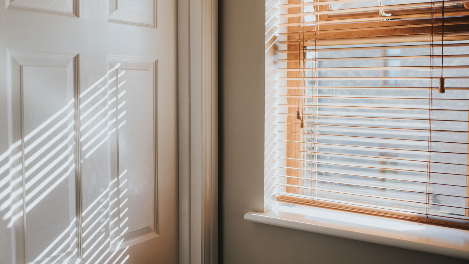 Sunlit wood blinds on a window