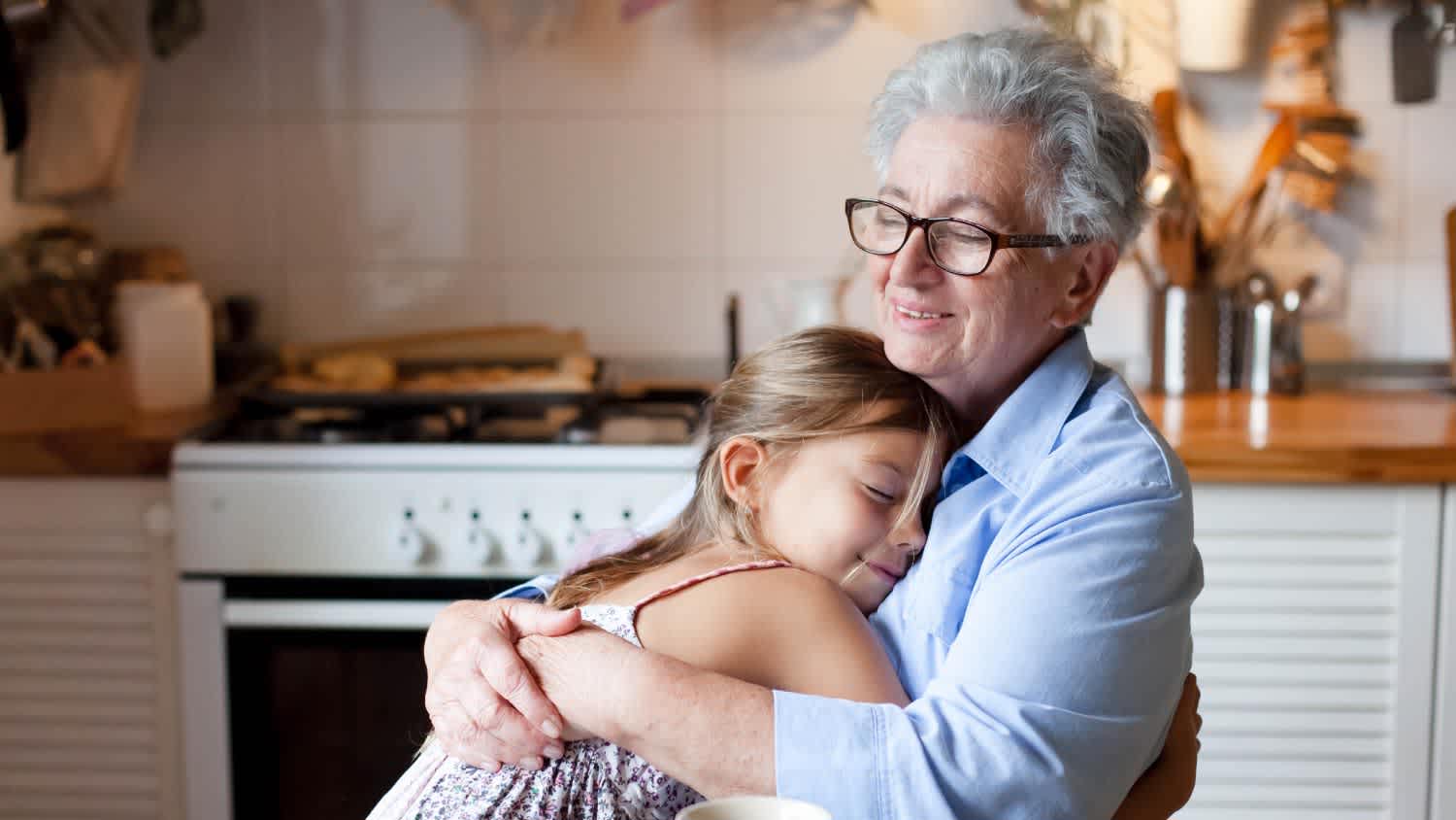 Grandmother hugging child at home