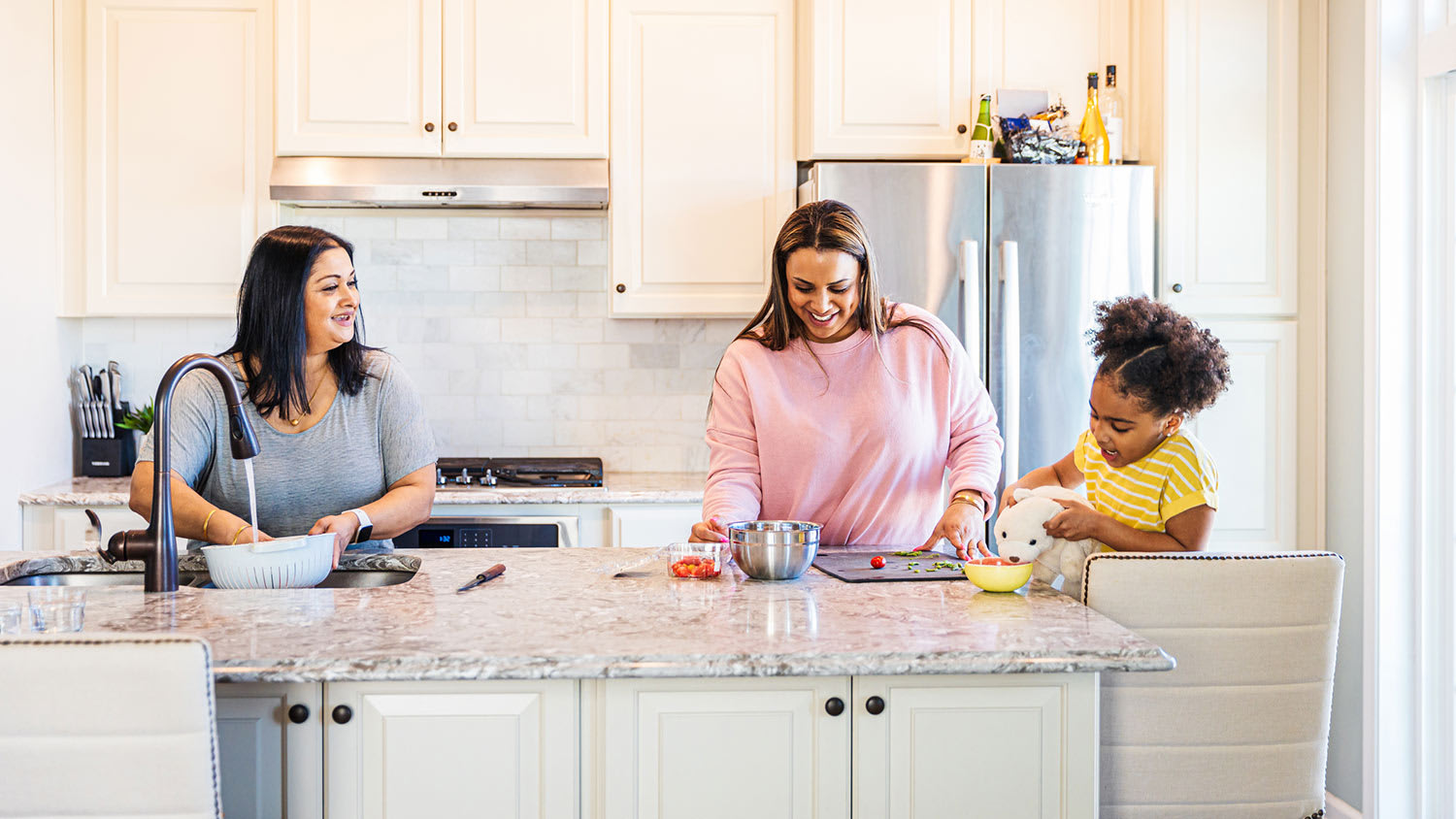 Three generations prepping food in the kitchen