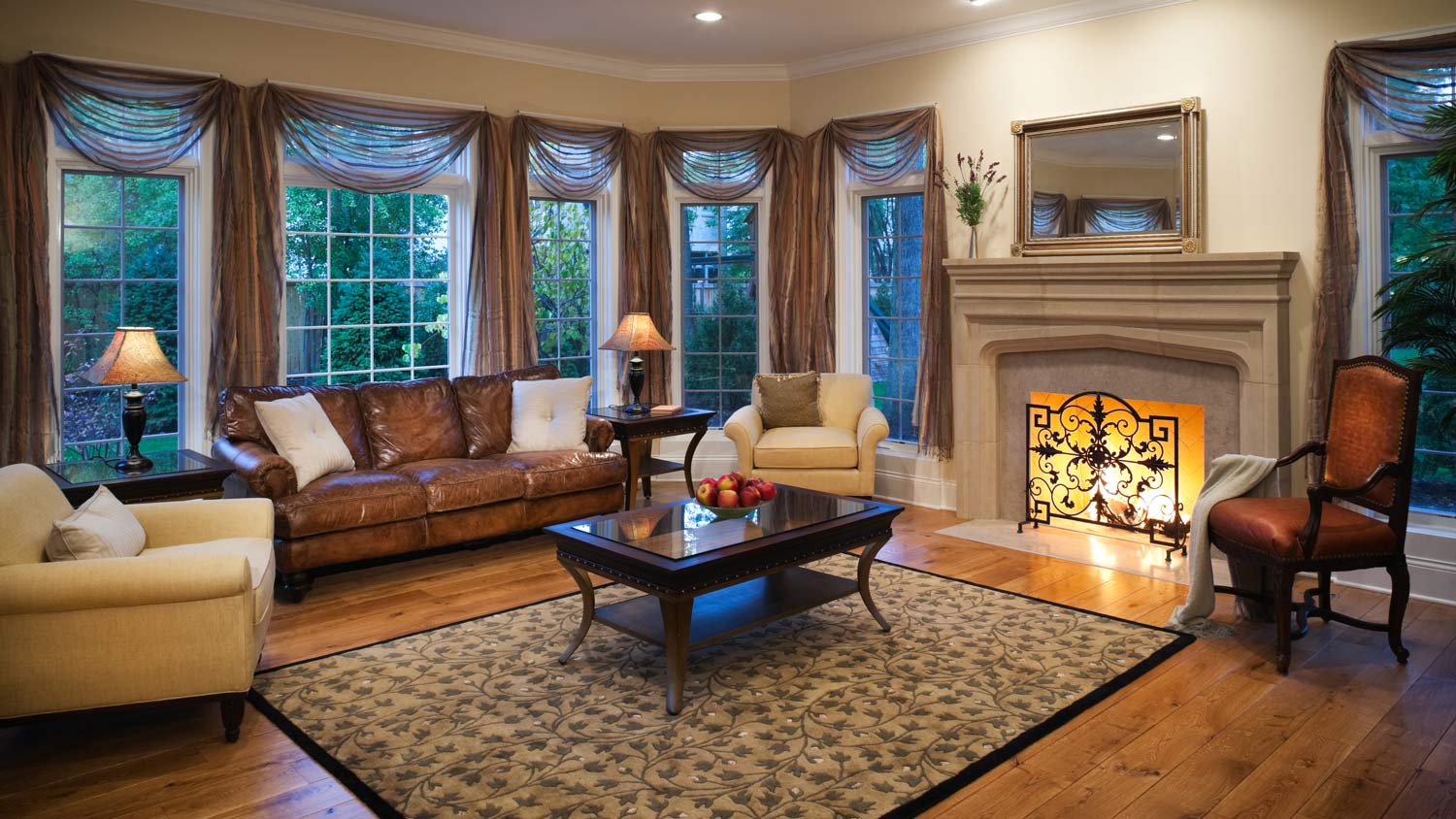 A living room with a fireplace and stationery panels over the curtains