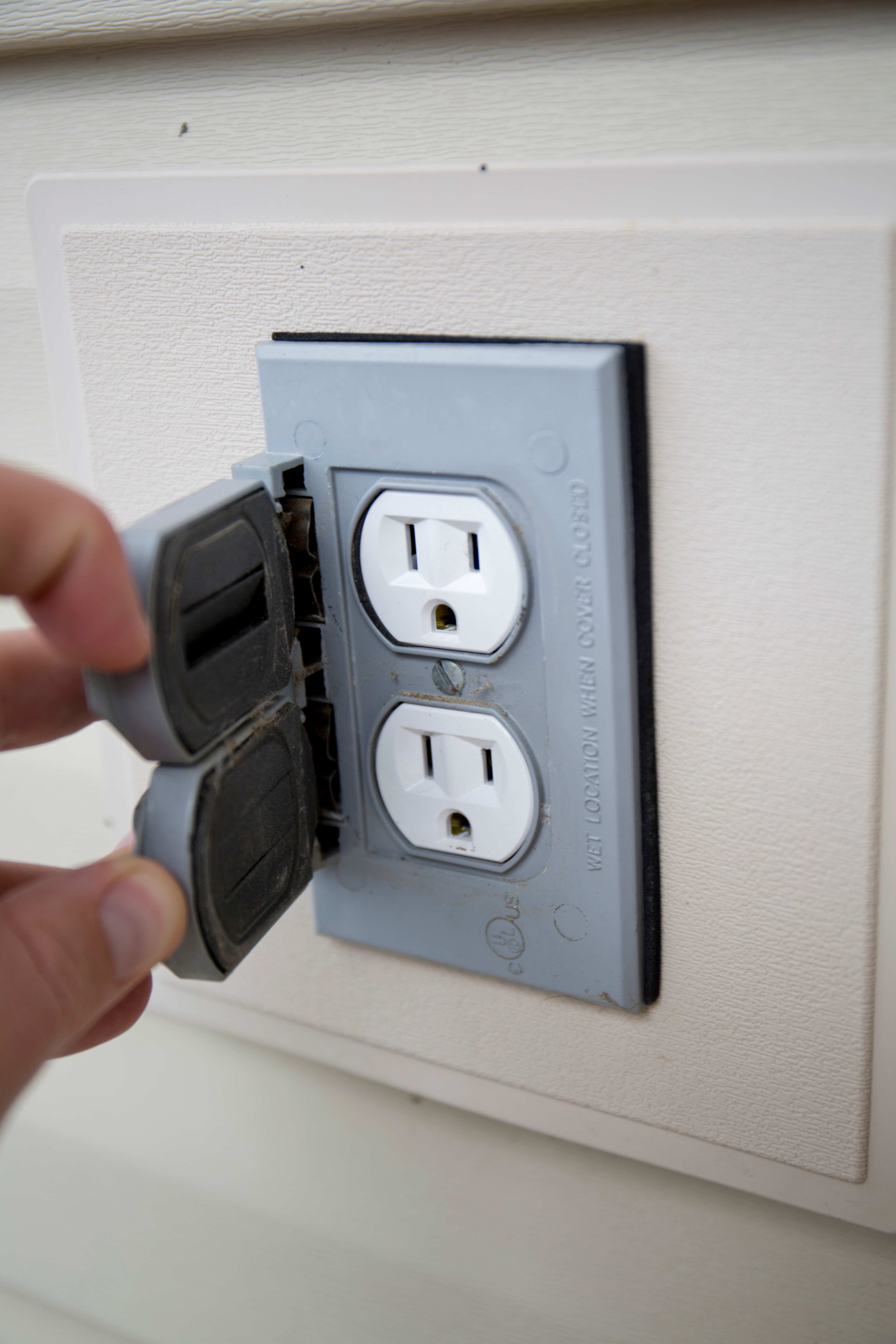 outdoor electrical outlet held open