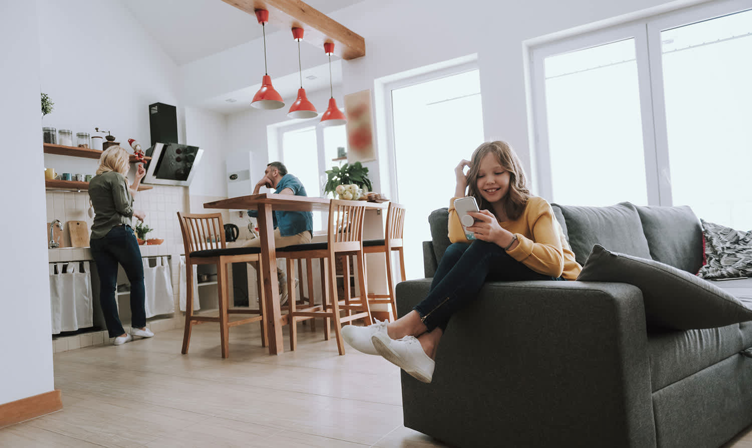 Family enjoying kitchen and living room open concept space