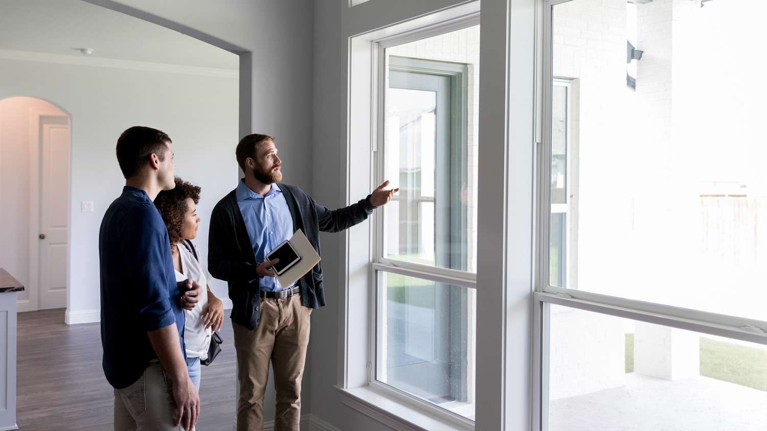 A contractor discussing with a couple in their new house