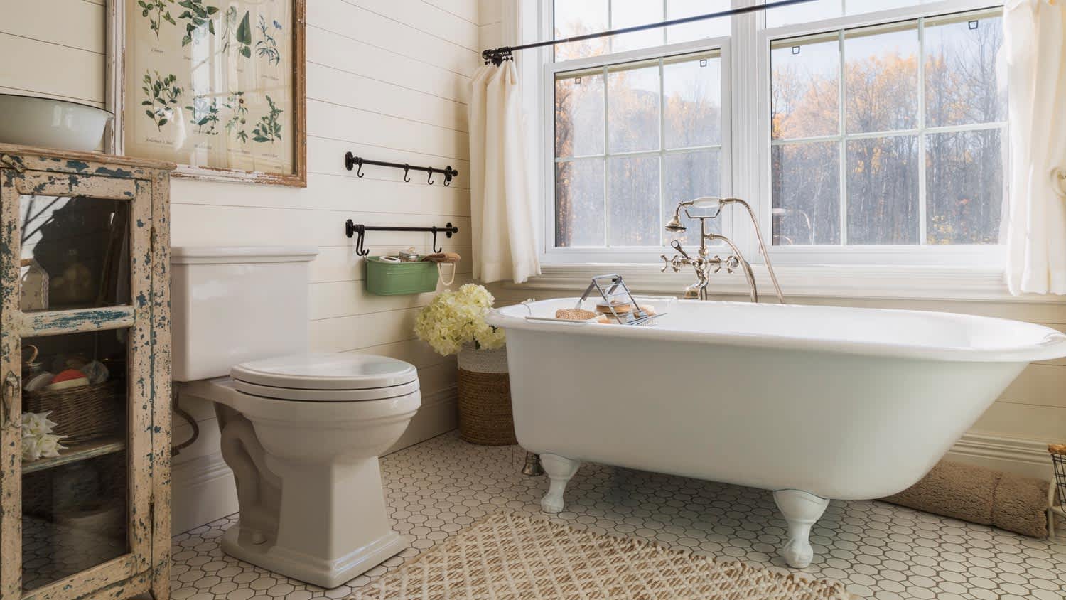 A bathroom with a white bathtub and tiled floor