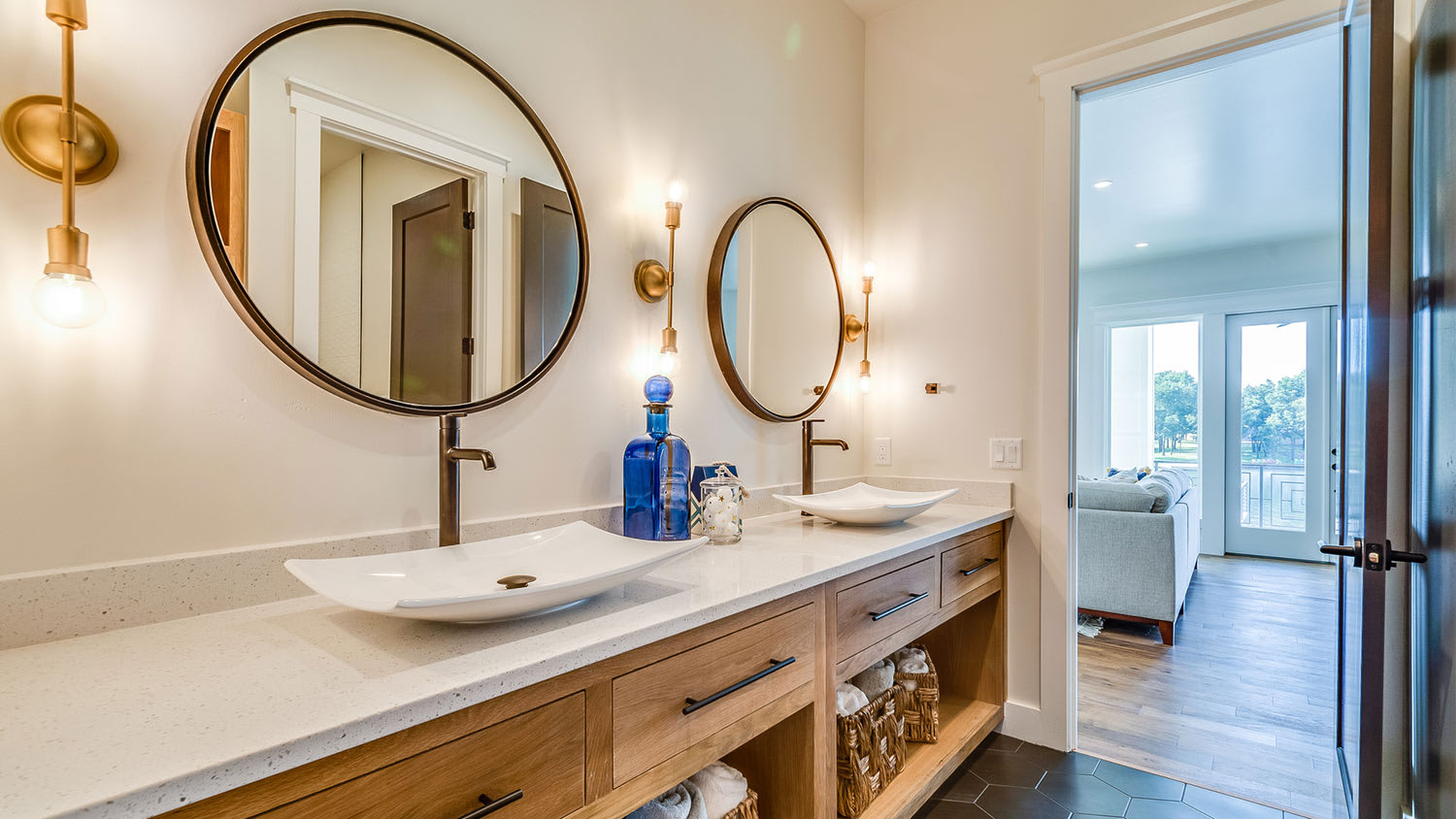 Bathroom with round mirrors above vessel sinks