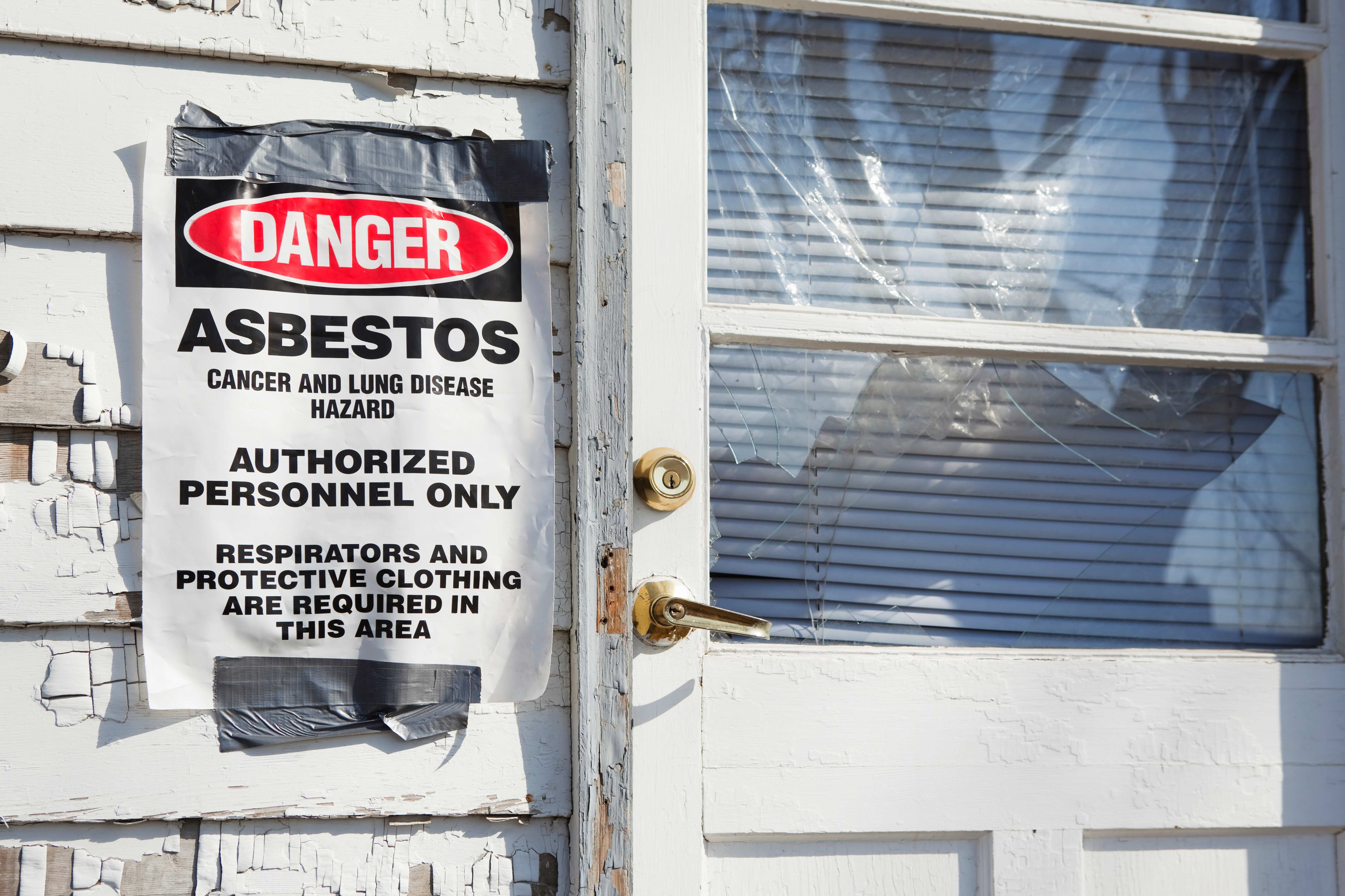 danger asbestos sign posted on house
