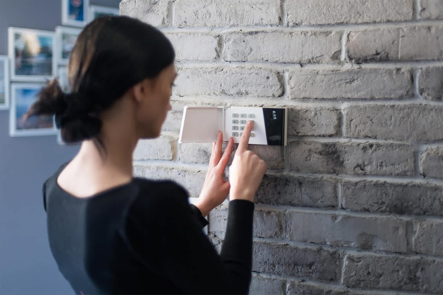 Woman arming home security system