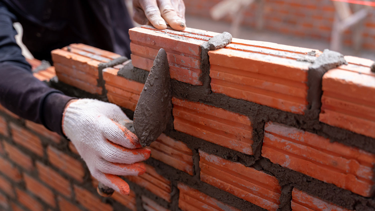 Close-up of a bricklayer worker on a construction site