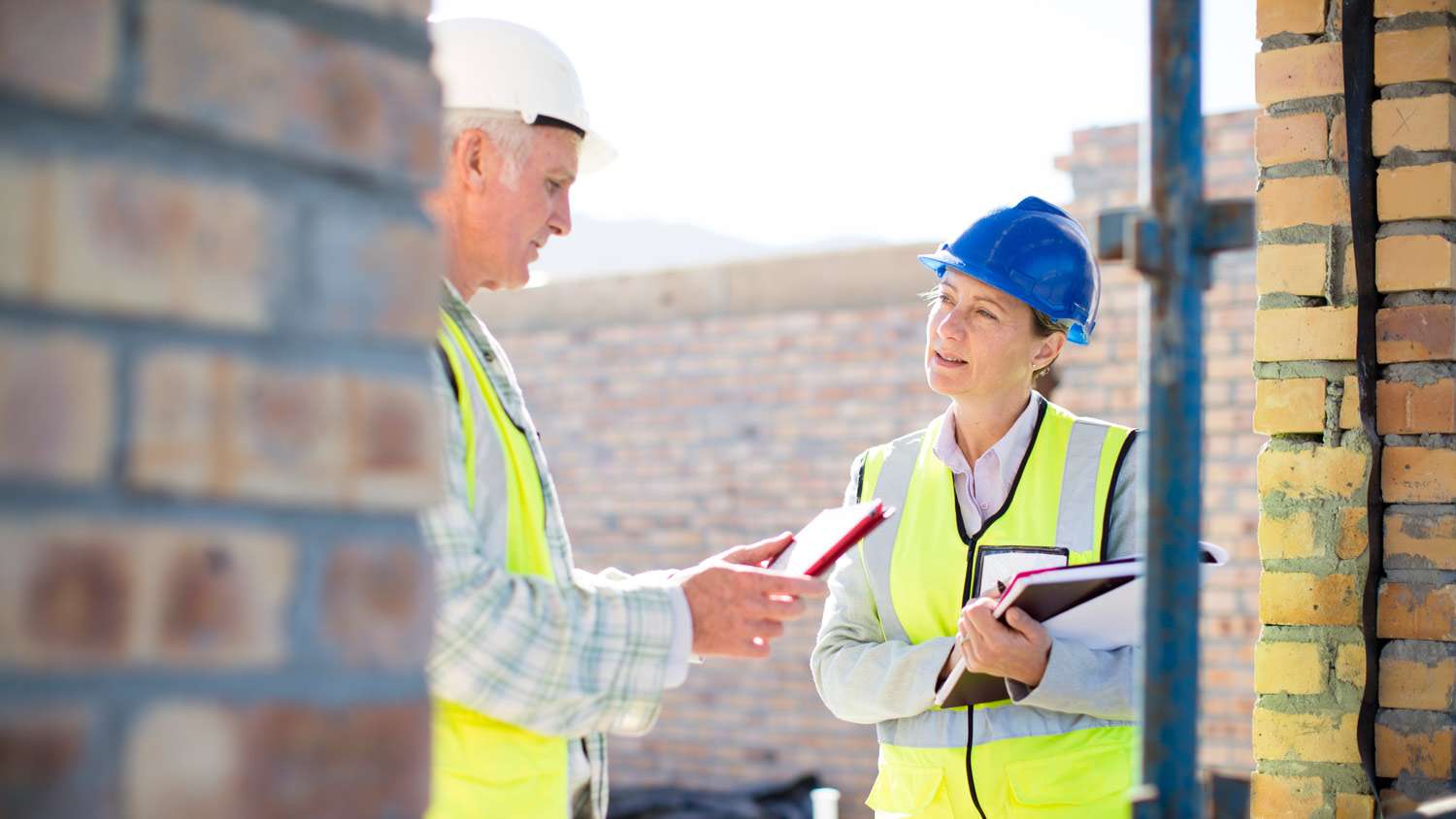 A builder and a contractor discussing at a construction site