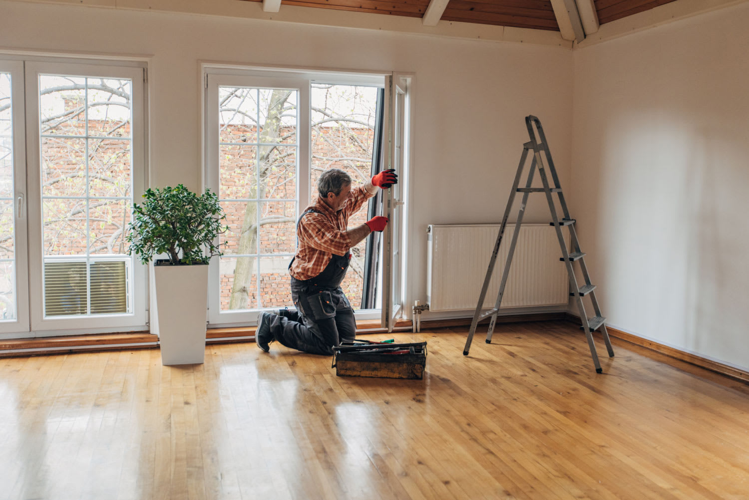 A handyperson repairing a window