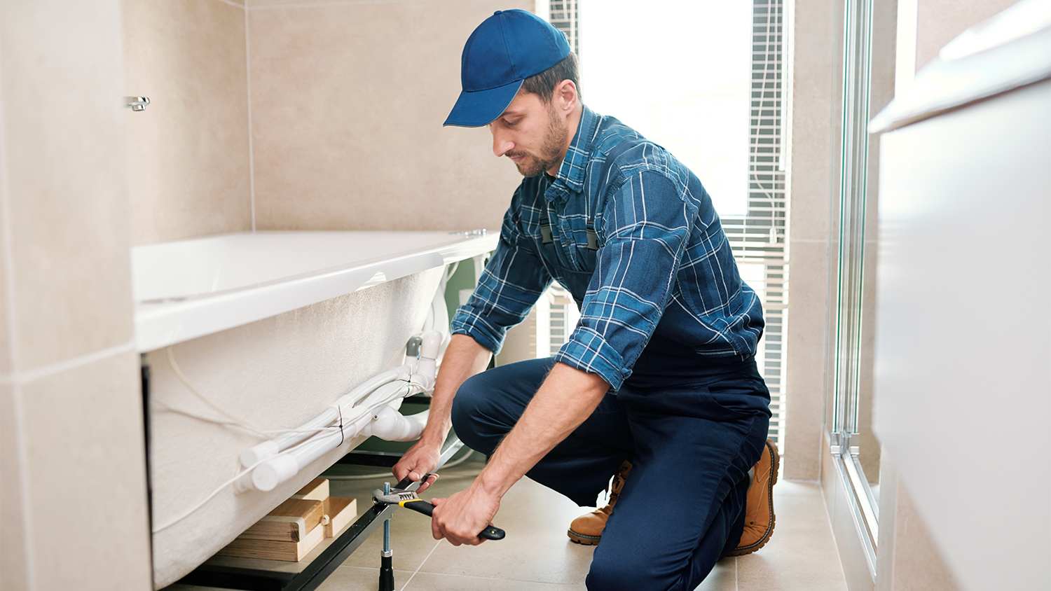 man installing bathroom mirror