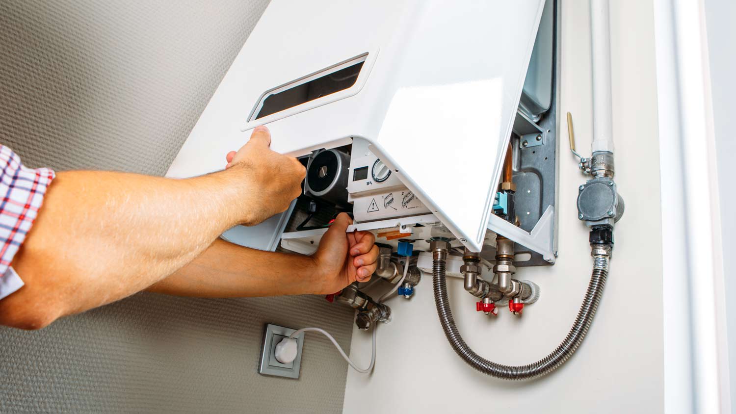 man inspecting water heater