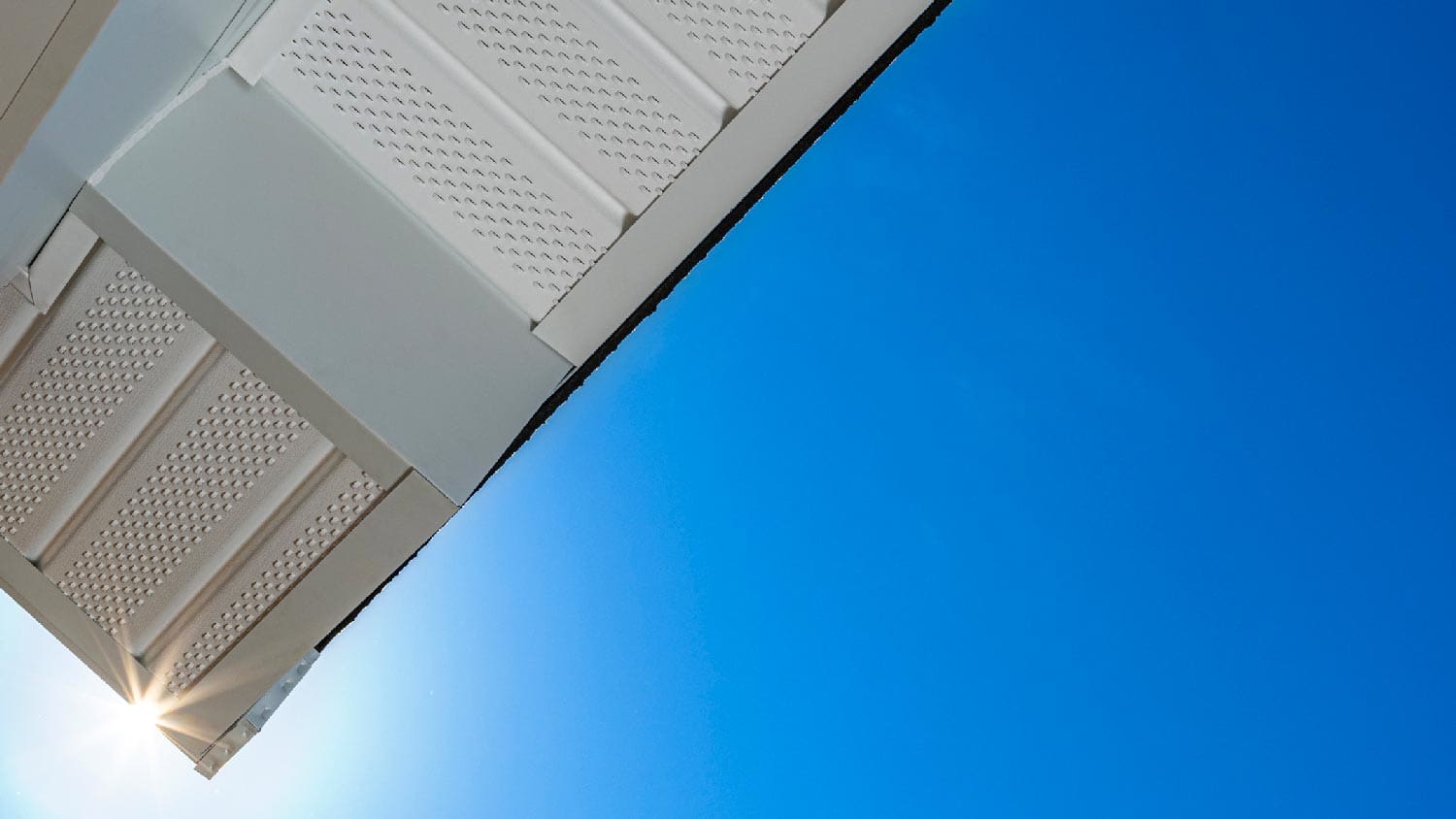None An aluminum soffit against the blue sky