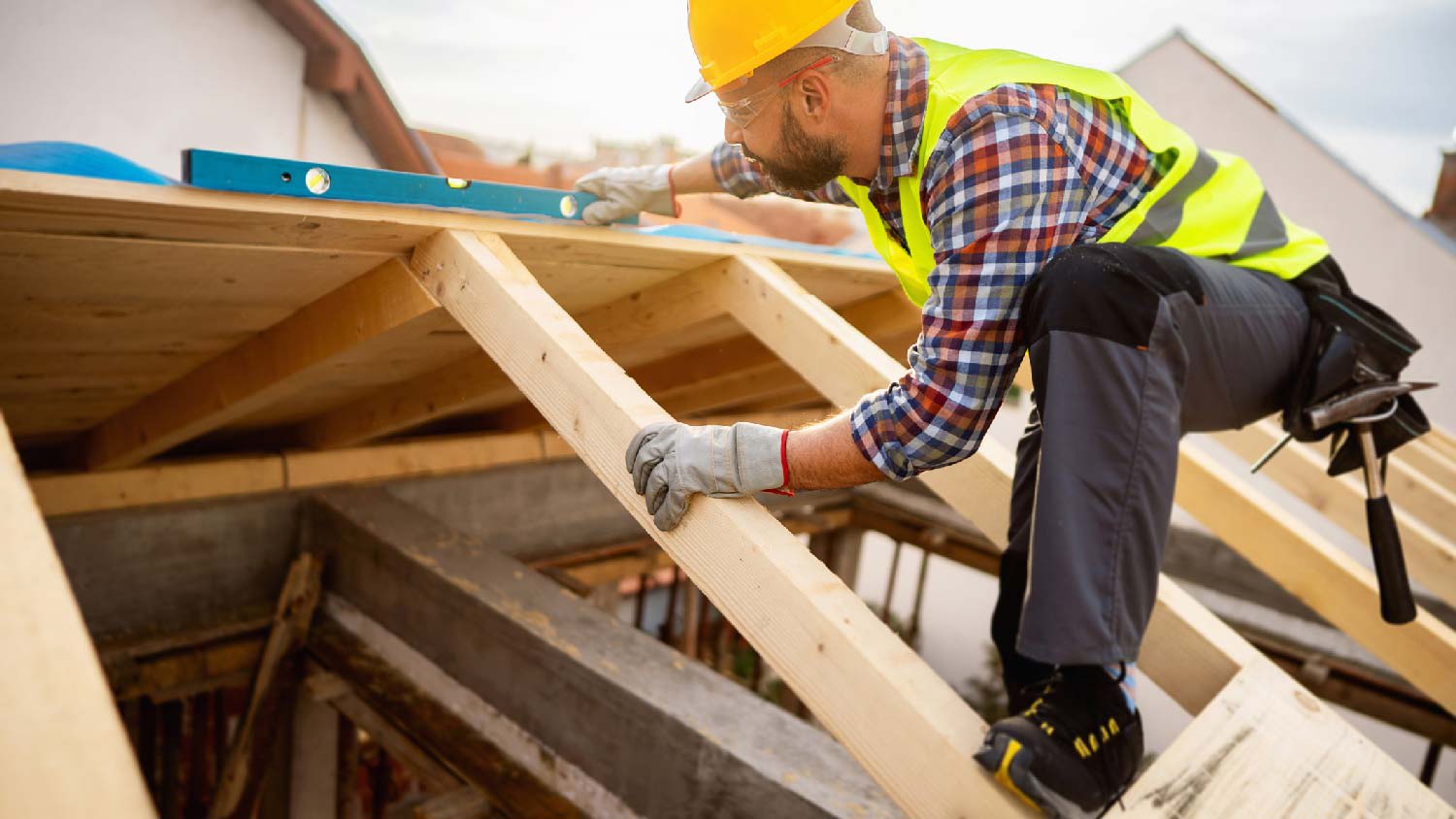 None A builder installing roof rafters