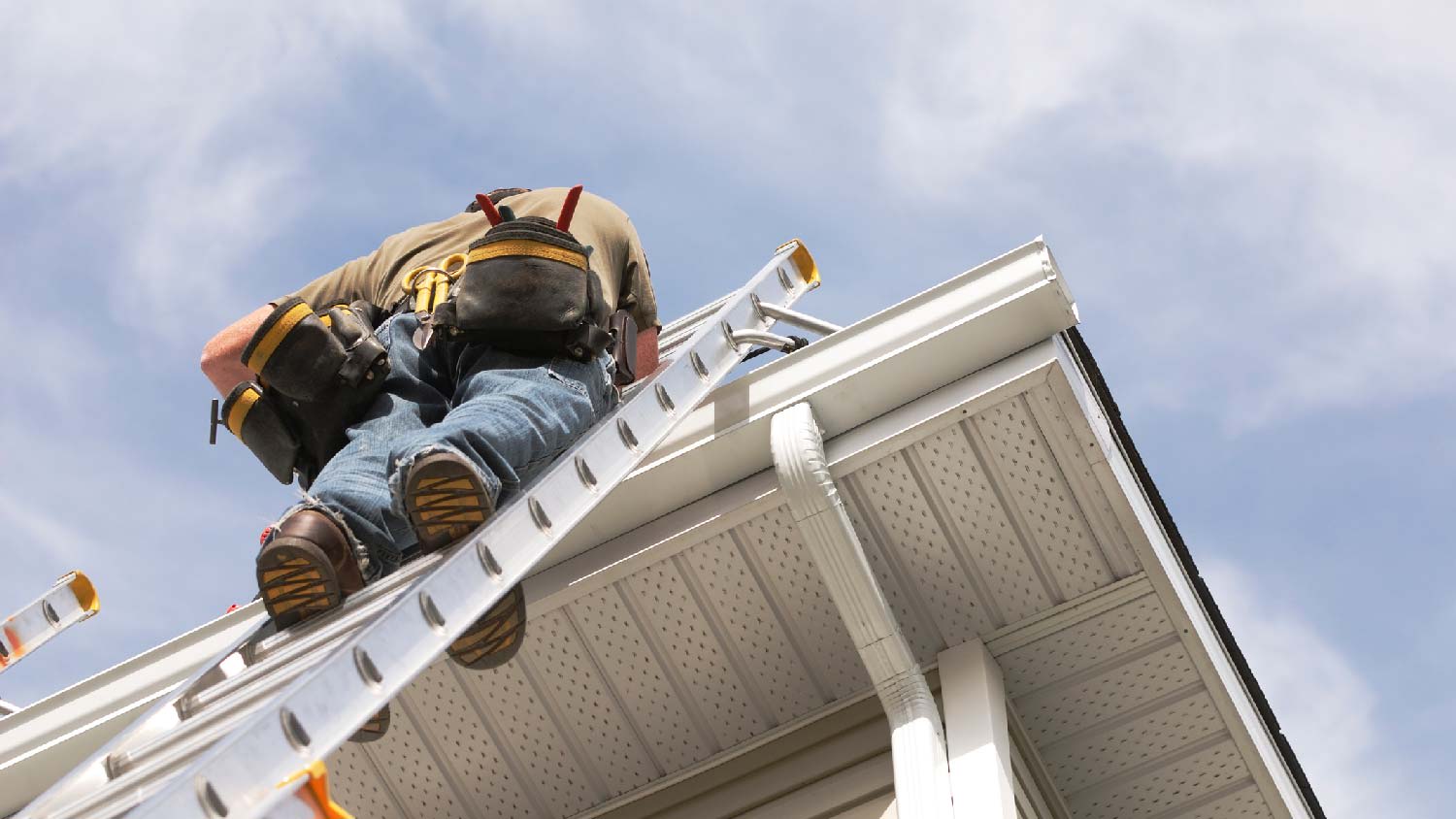 None A person inspecting a soffit