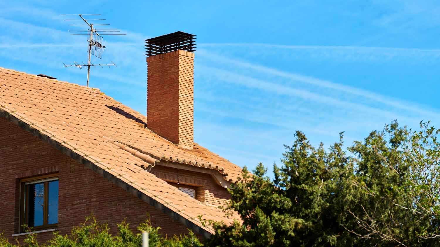 A red brick house with a chimney
