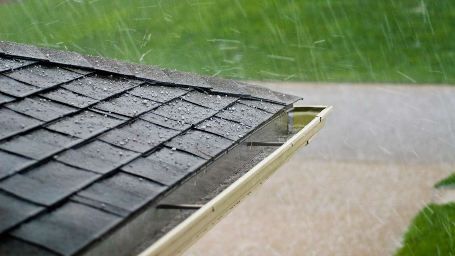 hailstone hitting roof shingles