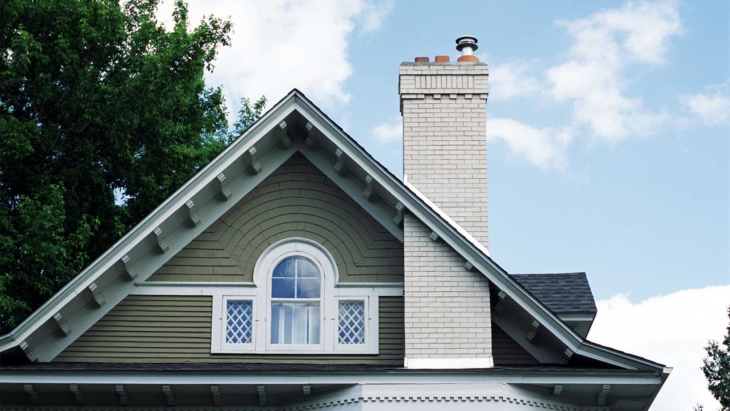 Exterior detail of a victorian house roof with chimney