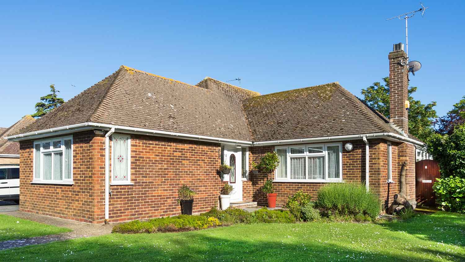 Brick house with a simple hip roof and chimney