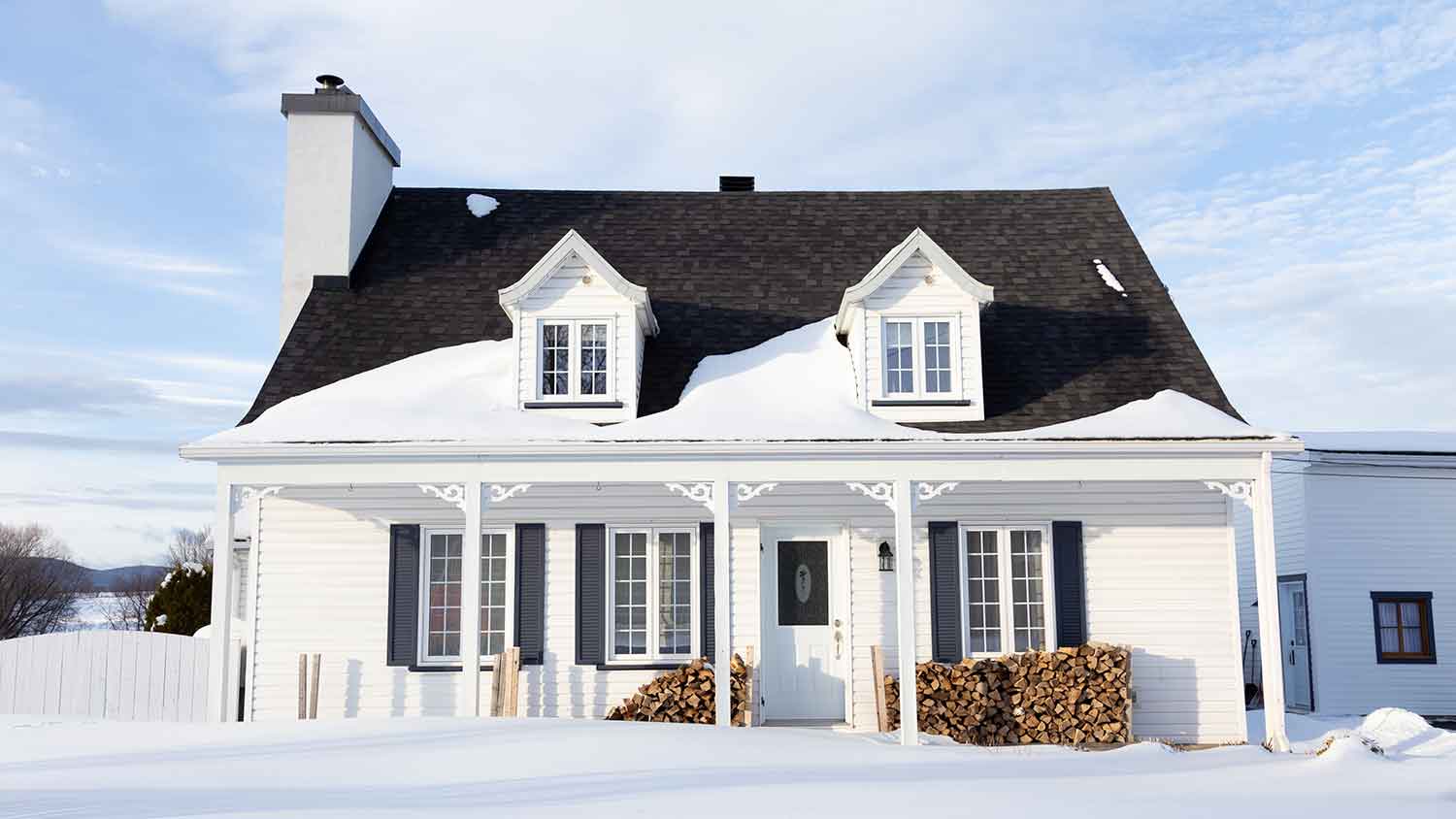 Exterior of a country house with snow melting on the roof