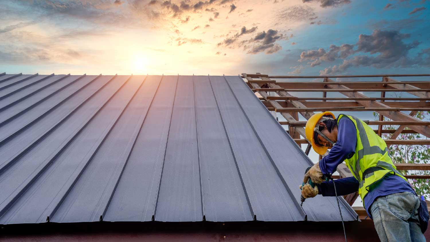None A worker installing a steel roof