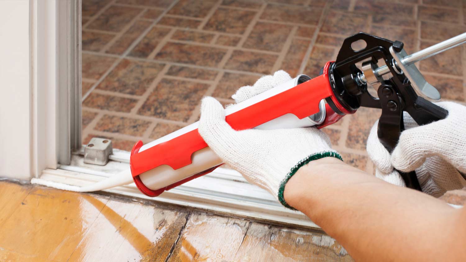 person using a caulk gun