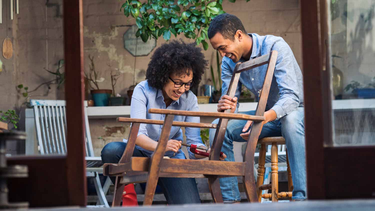 couple working together to restore a chair