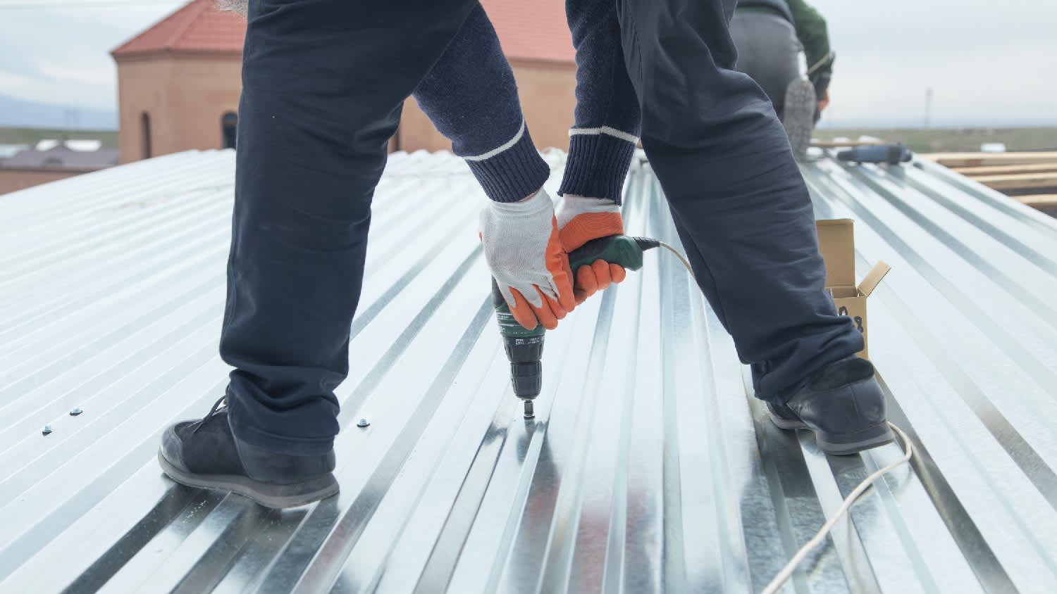 None A person repairing a steel roof