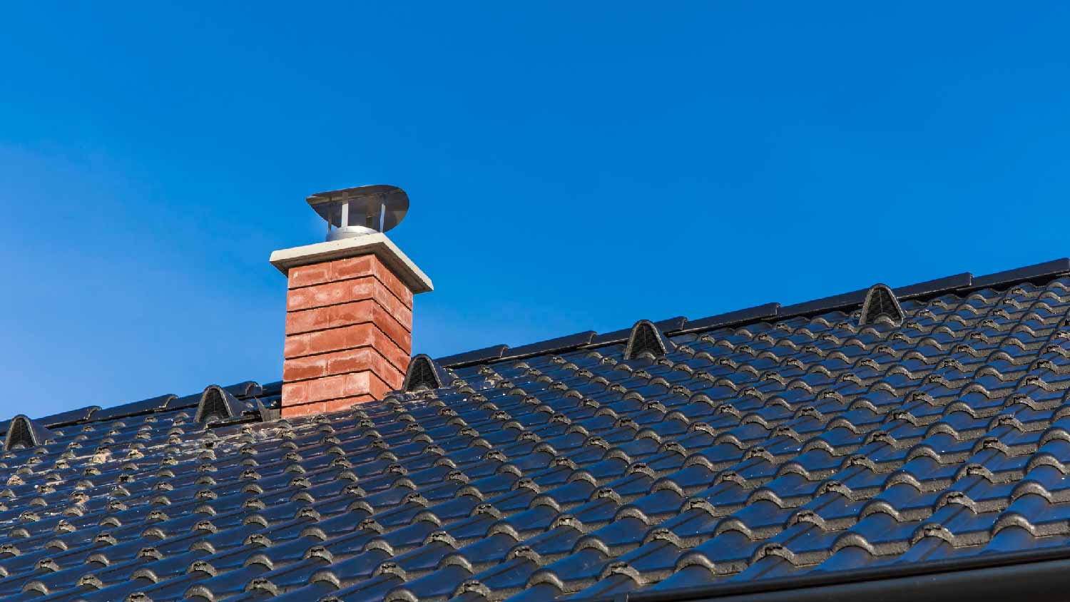 A roof with a brick chimney