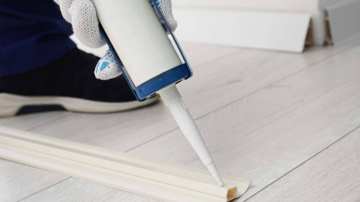 None Man using caulking gun