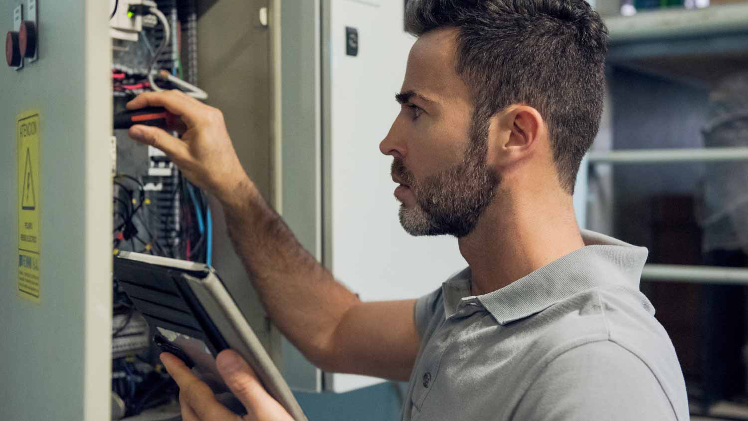 Man working in electrical control cabinet
