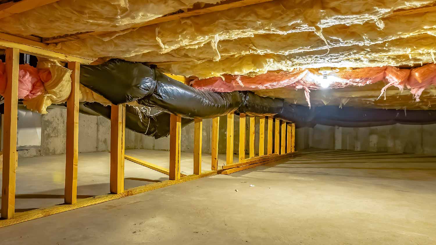 A crawl space with insulated ductwork