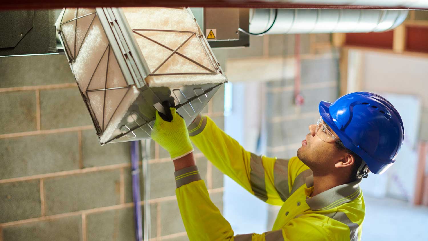 None A professional inspecting an air duct