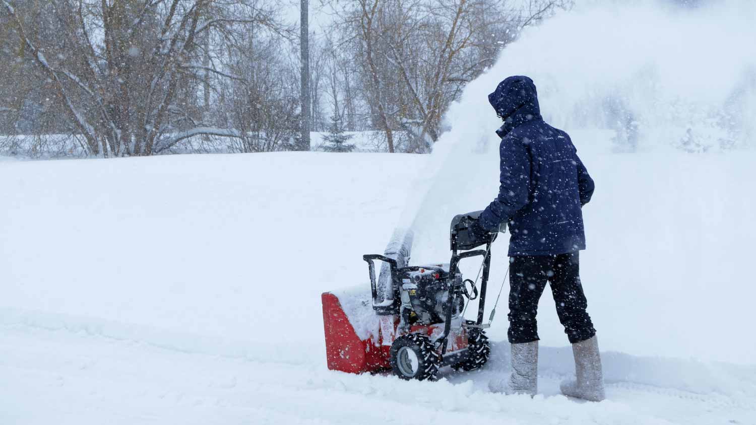 None Man using snow blower to clear driveway
