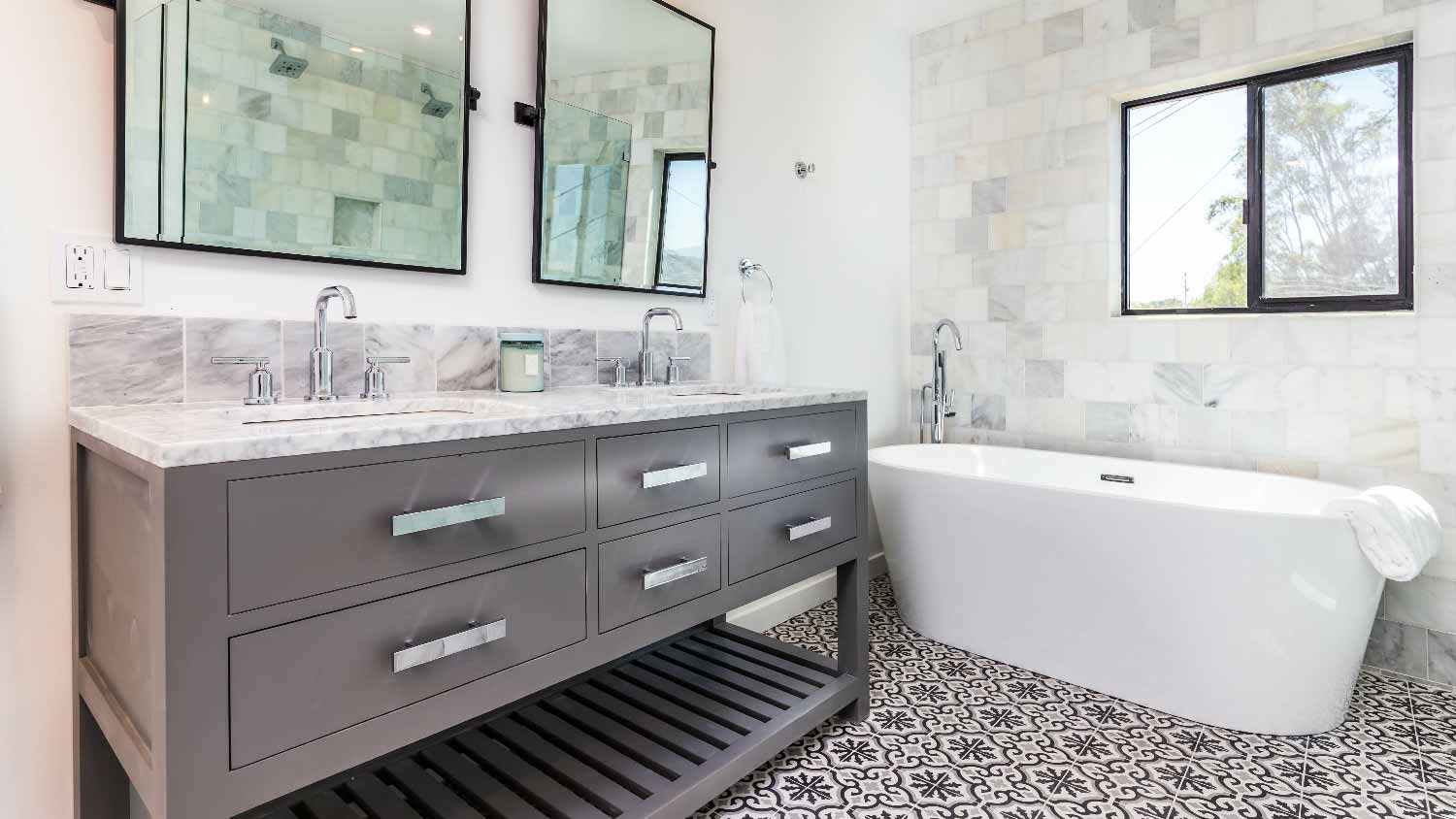 A bathroom with tiles and a double vanity