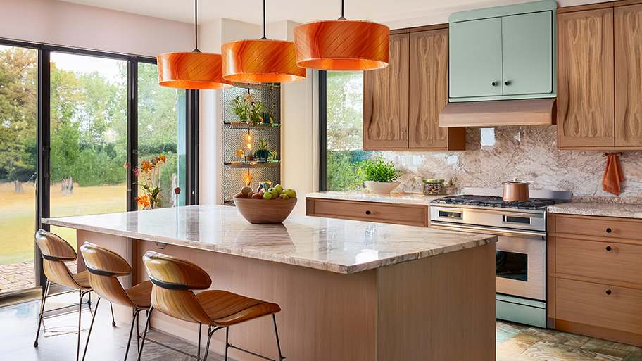 Pennsylvania kitchen according to AI, with a retro mid-century modern kitchen, with warm wooden cabinets, marble countertops, and eye-catching orange pendant lights
