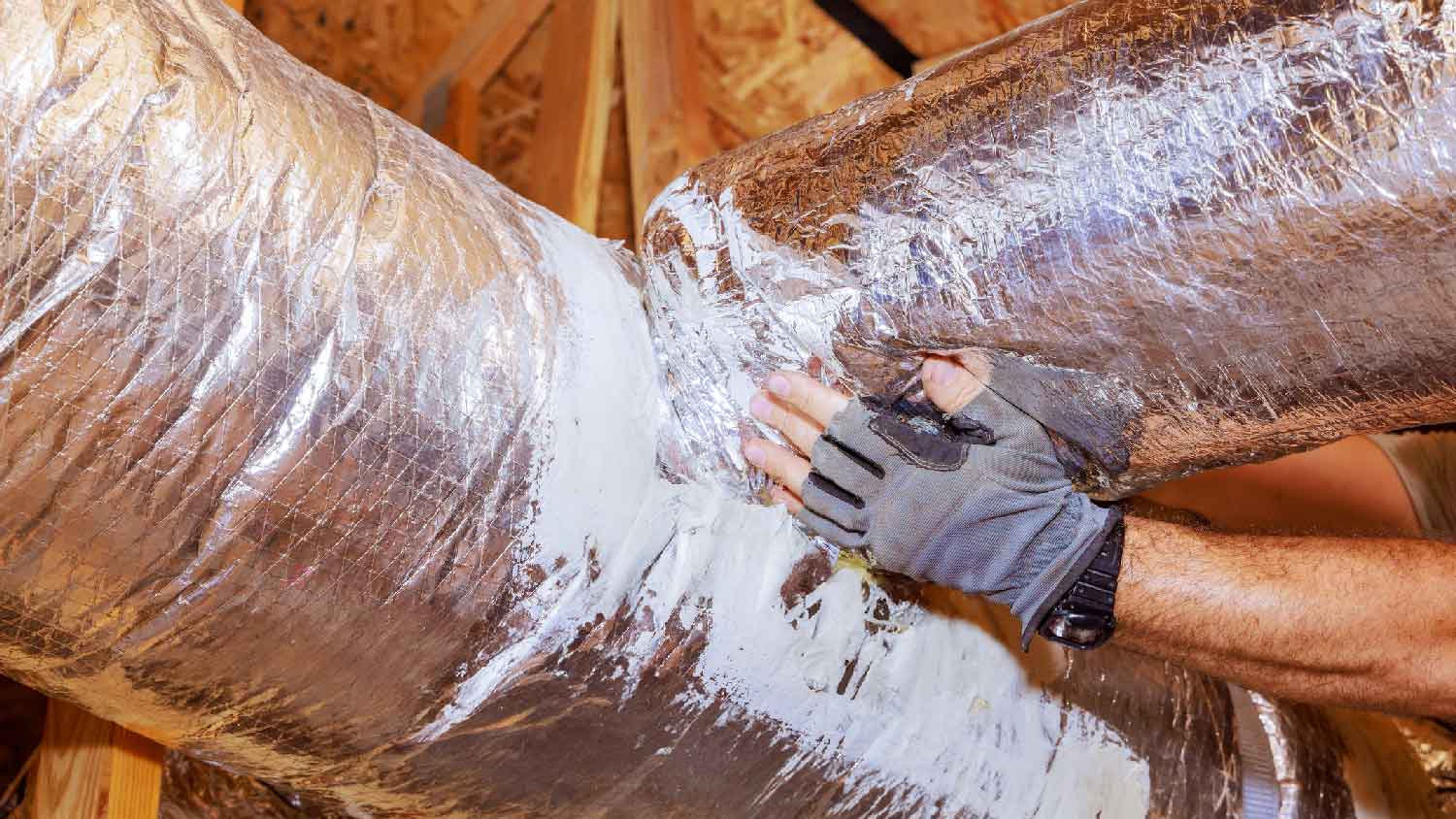 None A person installing ductwork