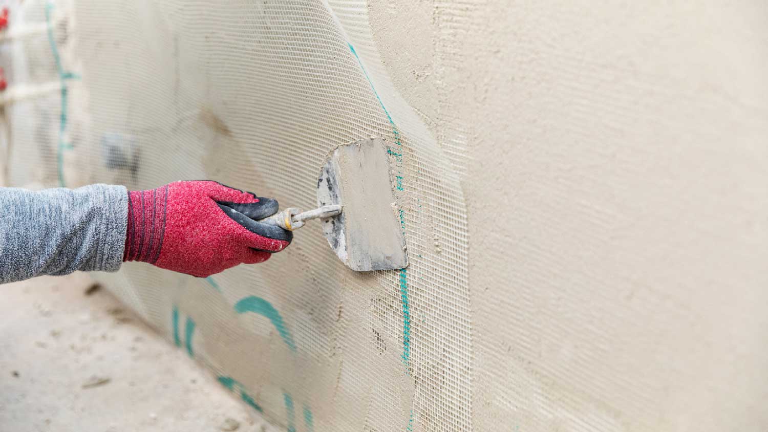 A person replacing stucco
