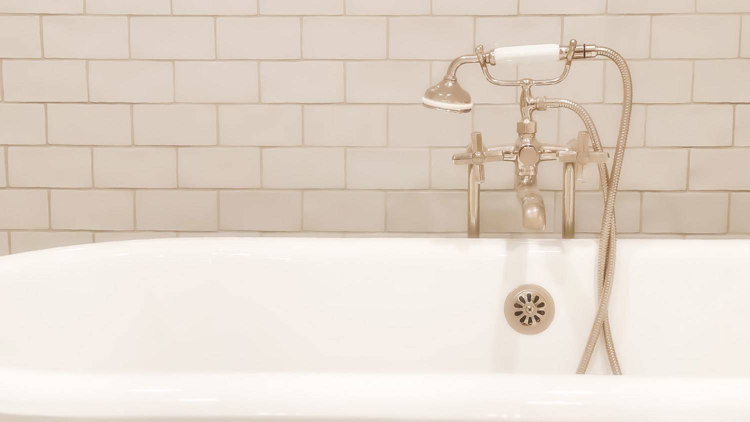 None Porcelain subway tiles in a traditional bathtub
