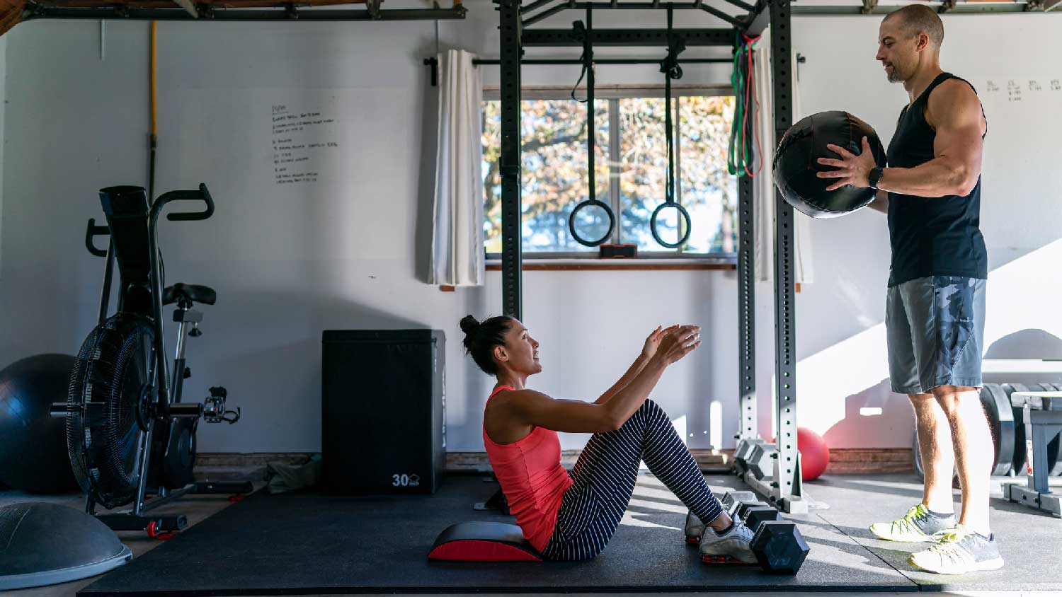 A couple working out in a home gym