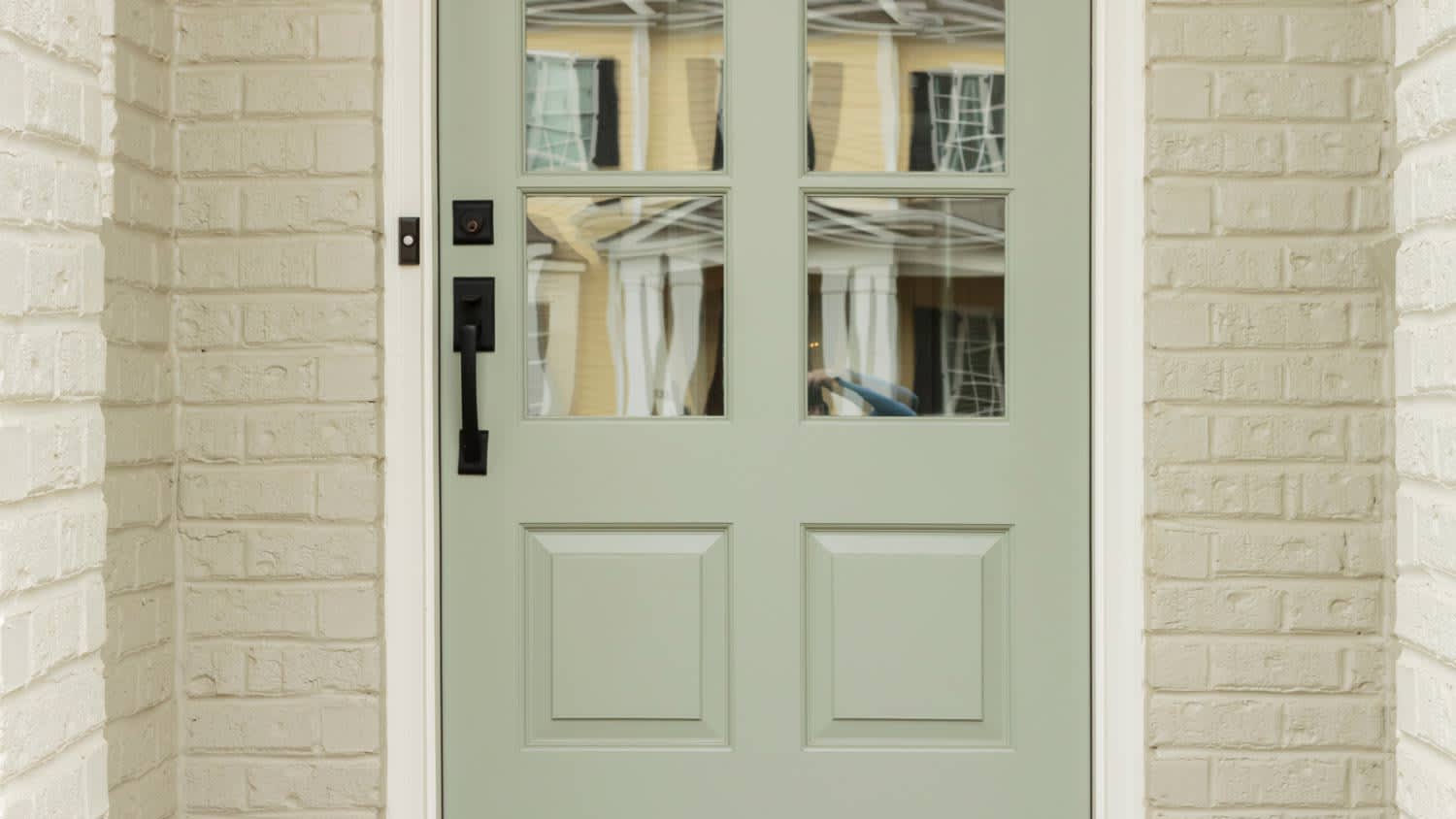 None green door with black pull handle