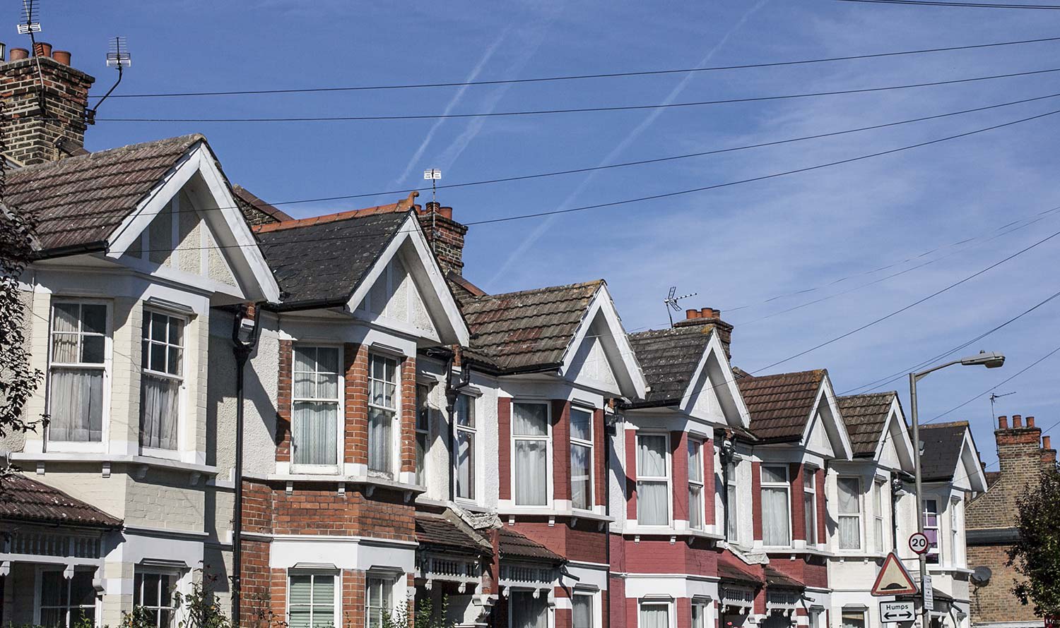 More powerlines running to row of houses