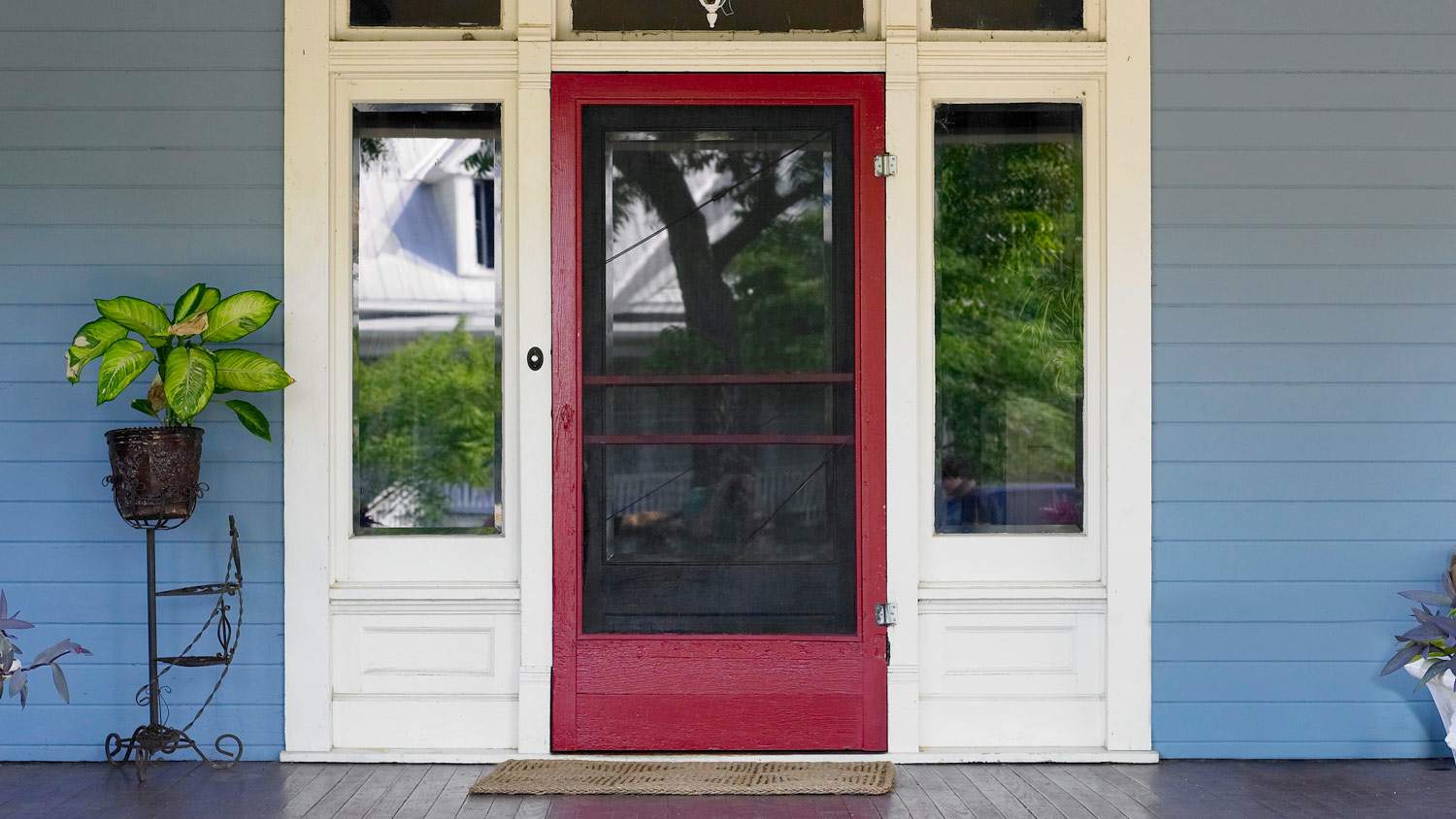 Red storm door on house exterior