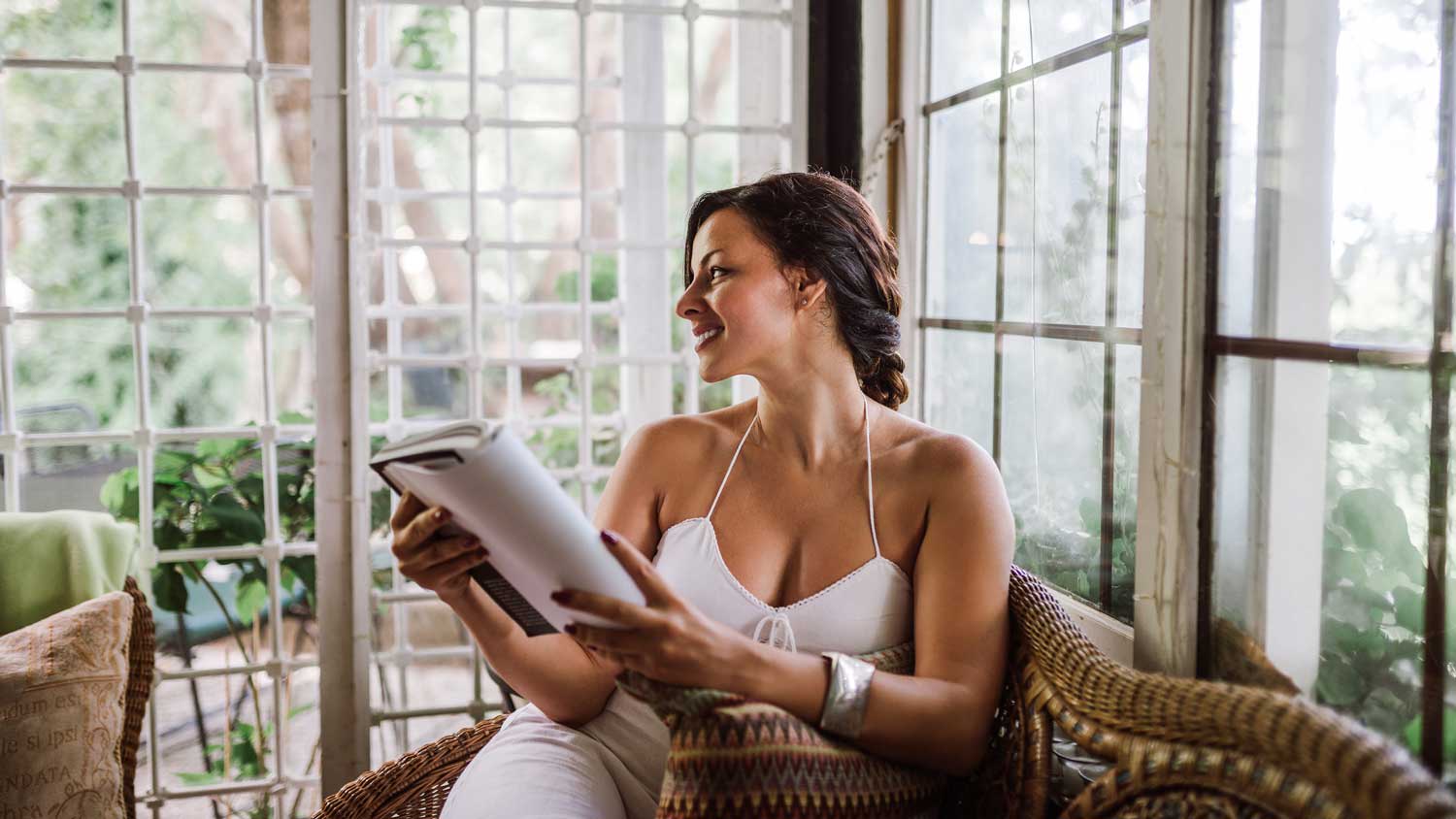 woman relaxing in home solarium