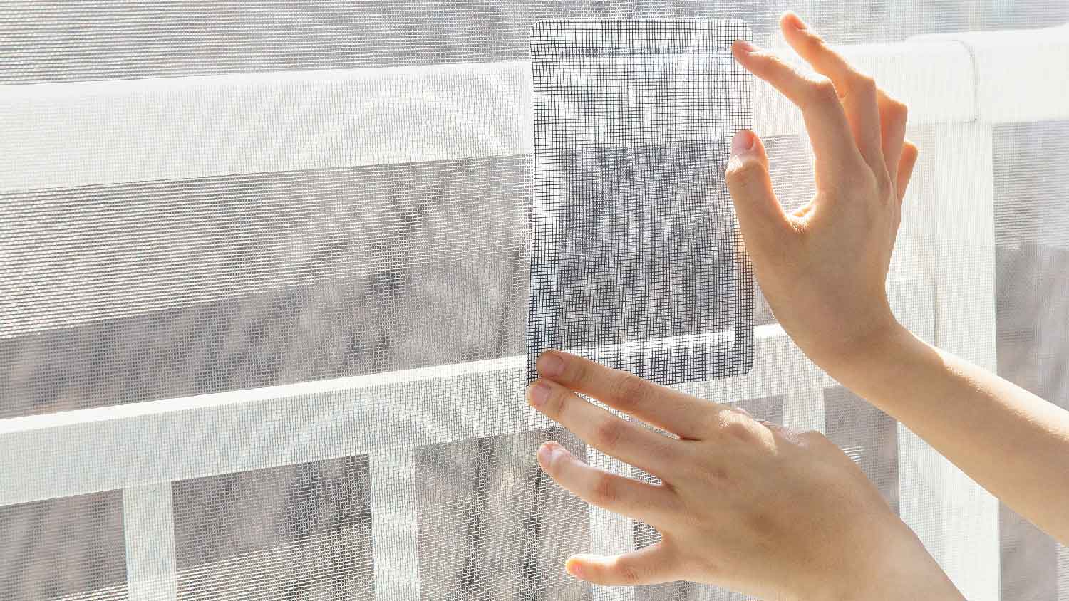 None A woman repairing a screen door