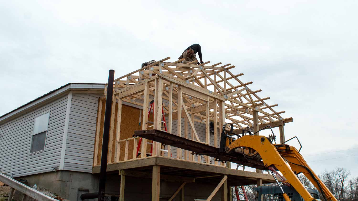 None Workers constructing an addition to a house