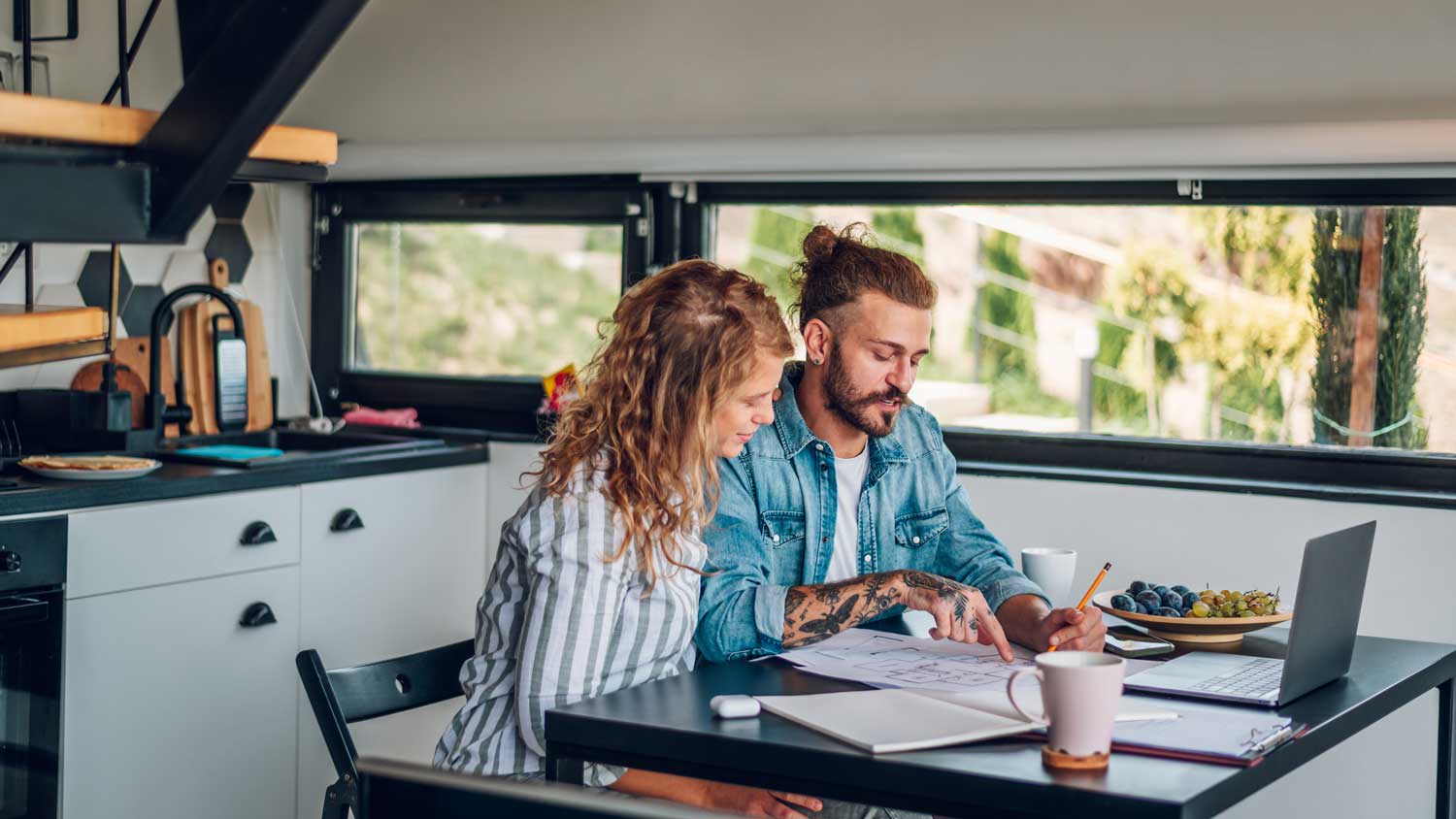 couple looking at blueprints of new home